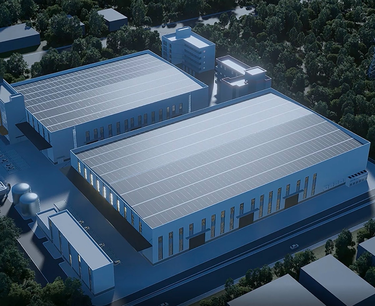 An aerial view of a large industrial building with a Solavita solar panel system installed on its roof illustrates a sustainable energy solution for commercial and industrial use. The image showcases the building's eco-friendly approach, using solar energy for operations